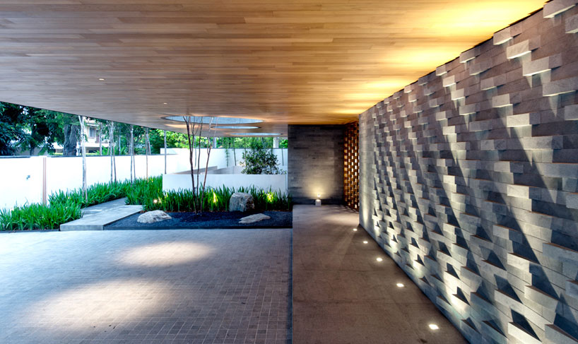 the wall house by FARM links two blocks with lush courtyard
