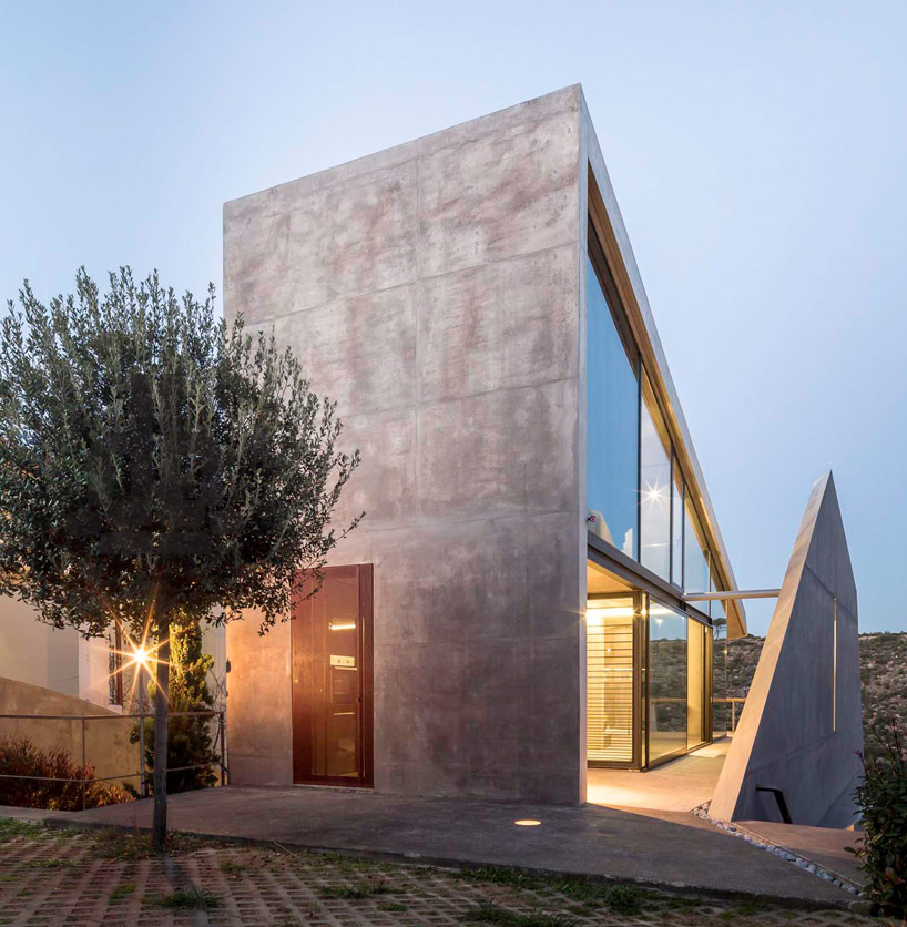 tense architecture network embeds home into a greek hill 
