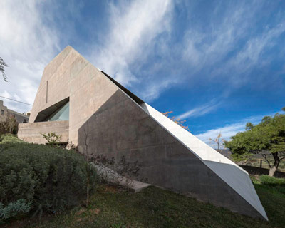 tense architecture network embeds home into a greek hill 