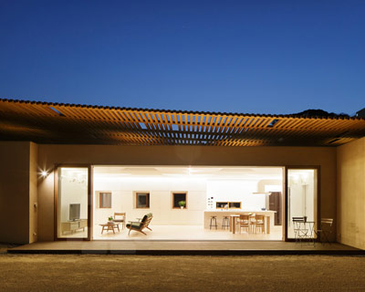 SUEP. double roof house features a floating reed screen