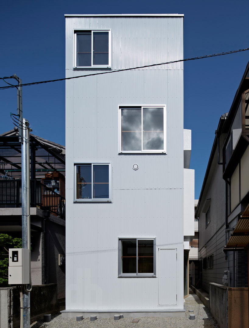 house in itami by tato architects sits on a narrow cul-de-sac