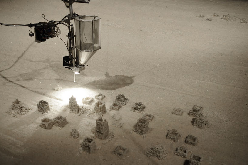 robot builds salt sculptures as visitors watch from a hot tub
