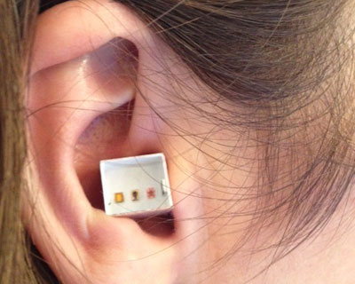 joe sola exhibits six microscopic paintings inside gallerist's ear