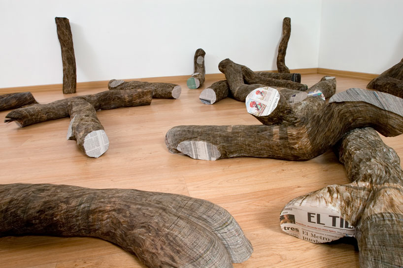 tree trunks made of densely stacked newspapers by miler lagos