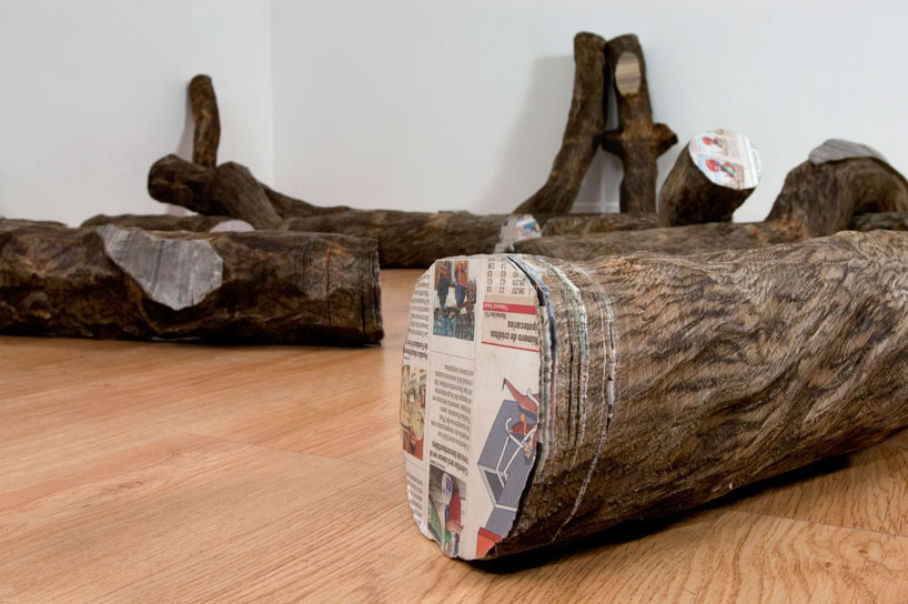 tree trunks made of densely stacked newspapers by miler lagos