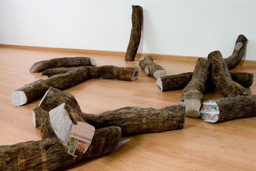 tree trunks made of densely stacked newspapers by miler lagos