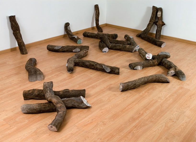 tree trunks made of densely stacked newspapers by miler lagos