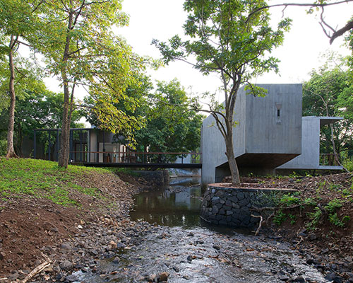 architecture brio weaves retreat house over stream in india