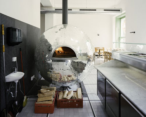 madame mohr centers pizzeria around rotating disco ball oven