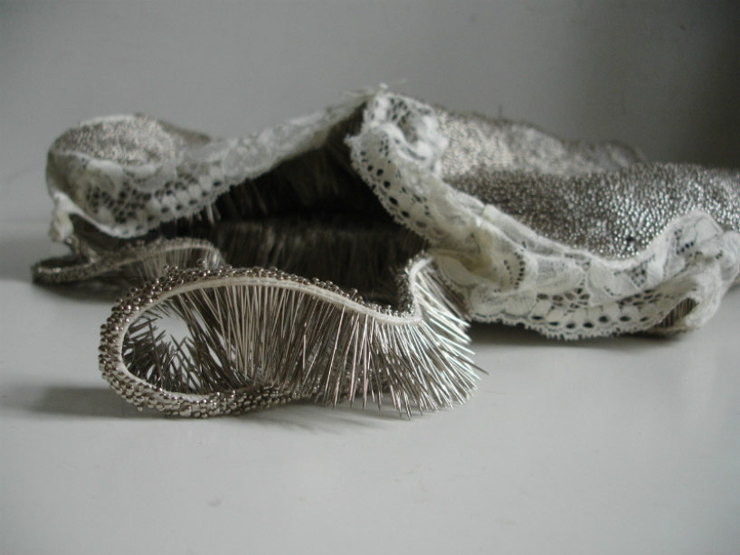 erwina ziomkowska pinches wardrobe garments with spiky pins