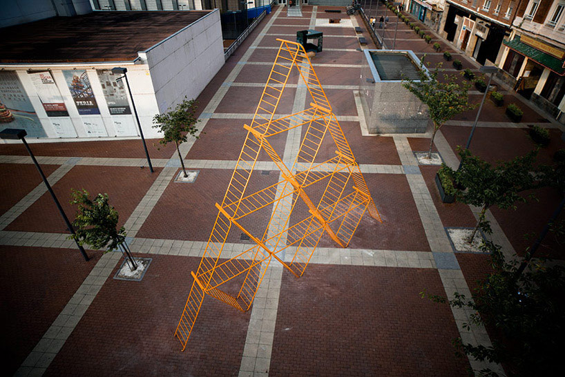 SpY urban art pyramid is constructed from safety barriers