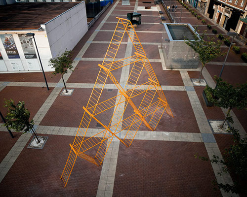 SpY urban art pyramid is constructed from safety barriers