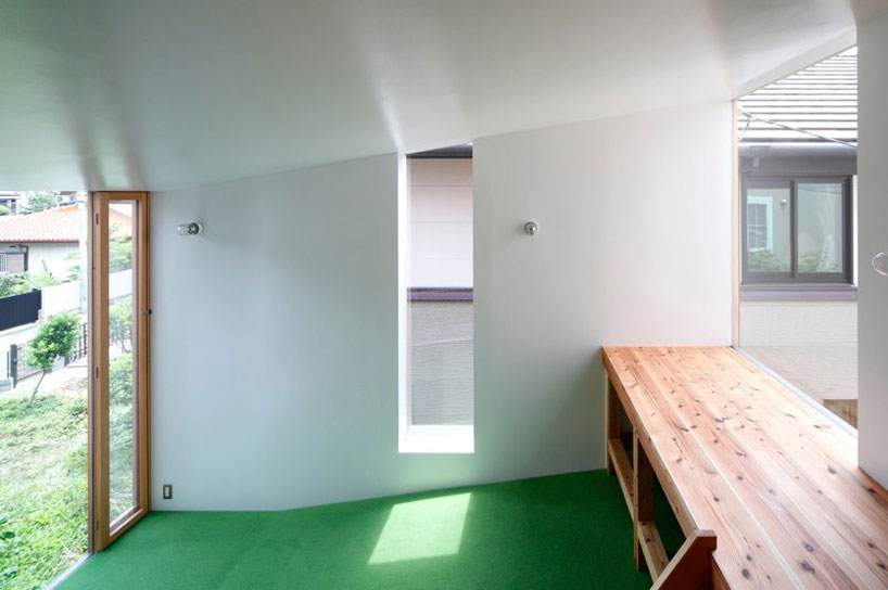 yaneura design sets hagoromo house amid neighboring homes