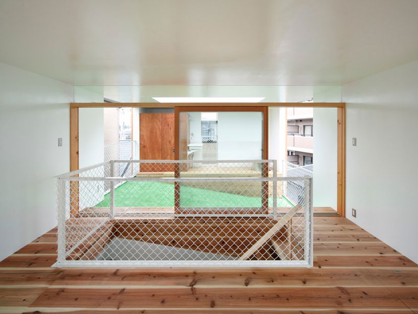 yaneura design sets hagoromo house amid neighboring homes