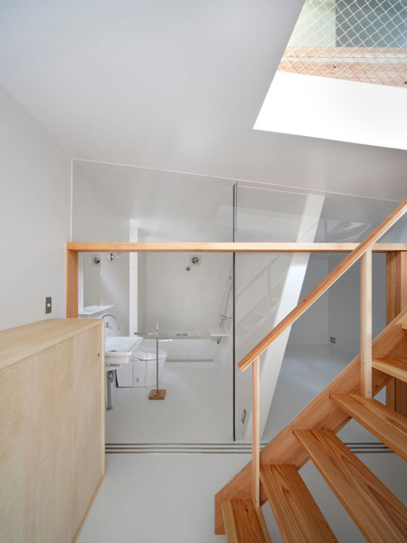 yaneura design sets hagoromo house amid neighboring homes