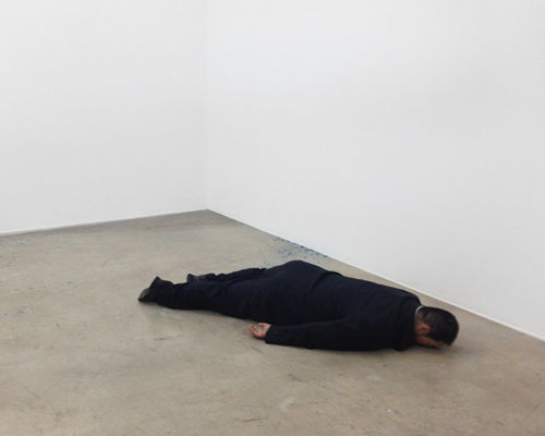 sculpted ai weiwei by he xiangyu lies face down on the ground