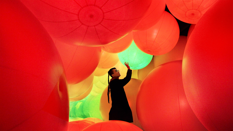 luminous colored spheres by teamlab respond to human touch