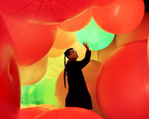 luminous colored spheres by teamlab respond to human touch