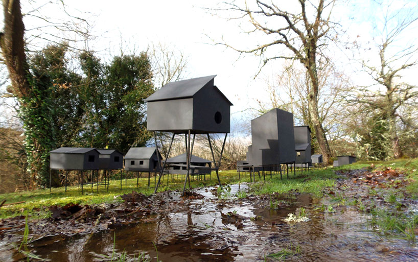 javier requejo installs black palafitos stilt houses in spain