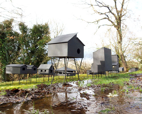 javier requejo installs black palafitos stilt houses in spain