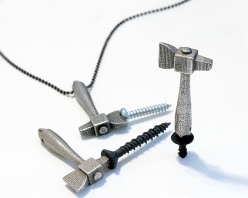 rob southcott's little hatchet pendant incorporates a flat head, phillips + robertson screwdriver