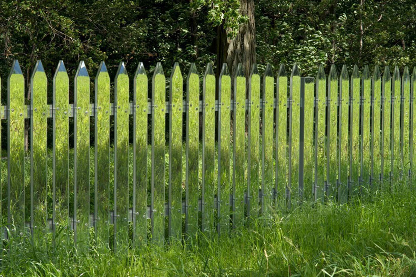 alyson shotz reflects green landscape with mirror fence