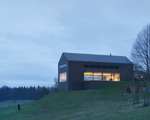 arhitektura d.o.o. reinterprets vernacular farmhouse with black barn