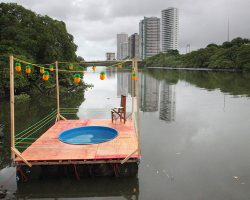 the 'praia' workshop floats swimming pool along polluted capibaribe river in recife