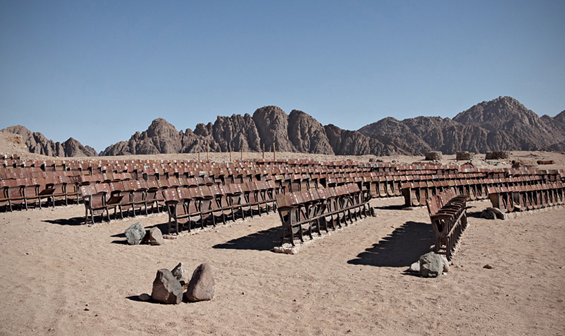 an abandoned movie theater lies in the middle of the egyptian desert
