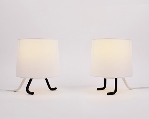 rising animates lamp shade with two walking legs at its base 