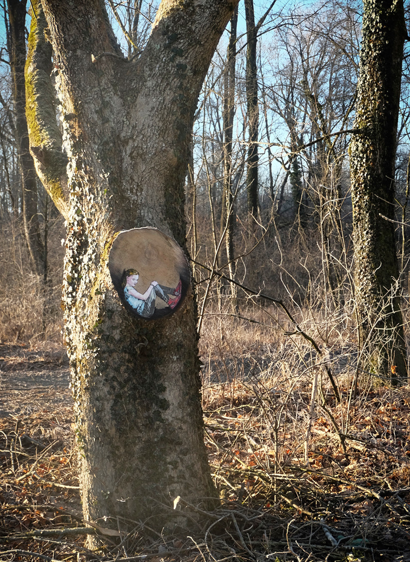 jana & js paint figures enclosed in tree trunk circles