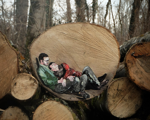 jana & js paint figures in the forest enclosed in tree trunk rings