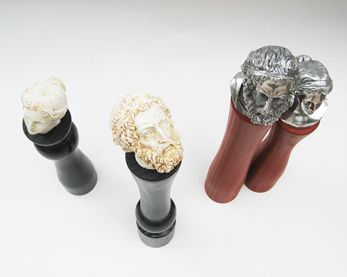 panos velentzas attaches greek god figurines onto pepper grinders