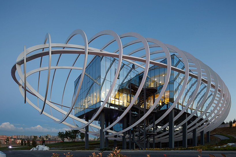 yazgan design architecture encases tema istanbul showroom with elliptical exterior