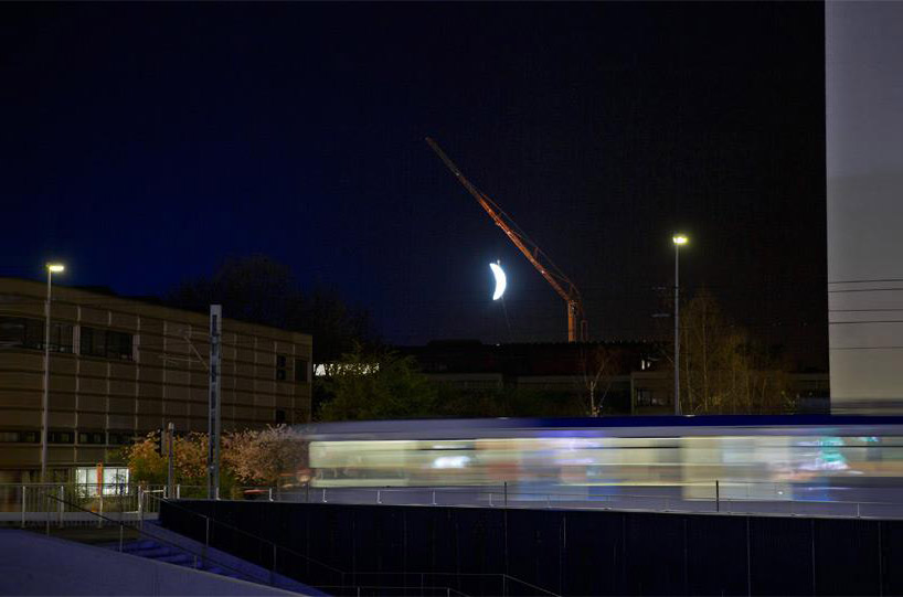 SpY sets a glowing crescent moon above the swiss landscape