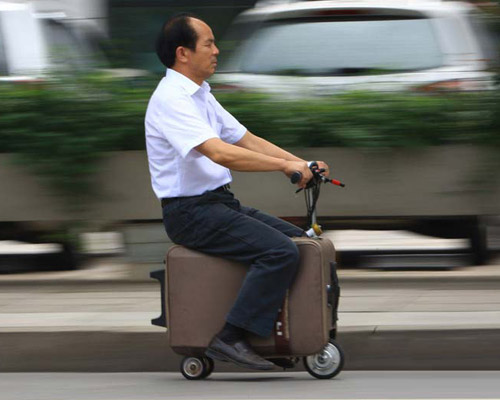 chinese man builds a fully-functioning suitcase scooter 