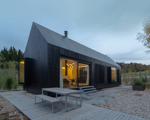 format elf nestles dark barn-shaped houses into bavarian forest