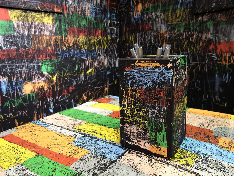 itay ohaly etches onto black walls to reveal colored memories