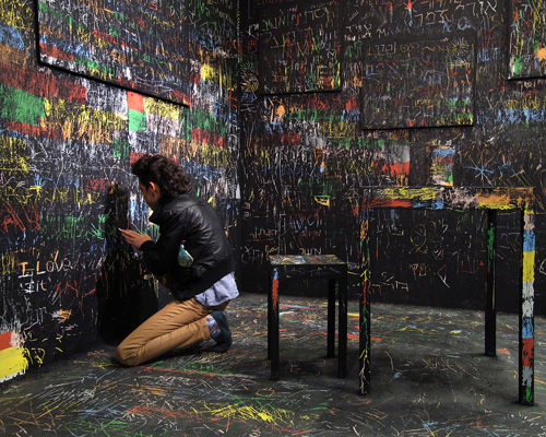 itay ohaly etches onto black walls to reveal colored memories