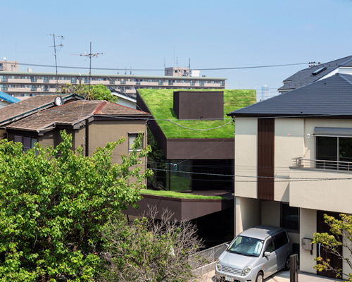 makiko tsukada angles grass cave house between suburban homes