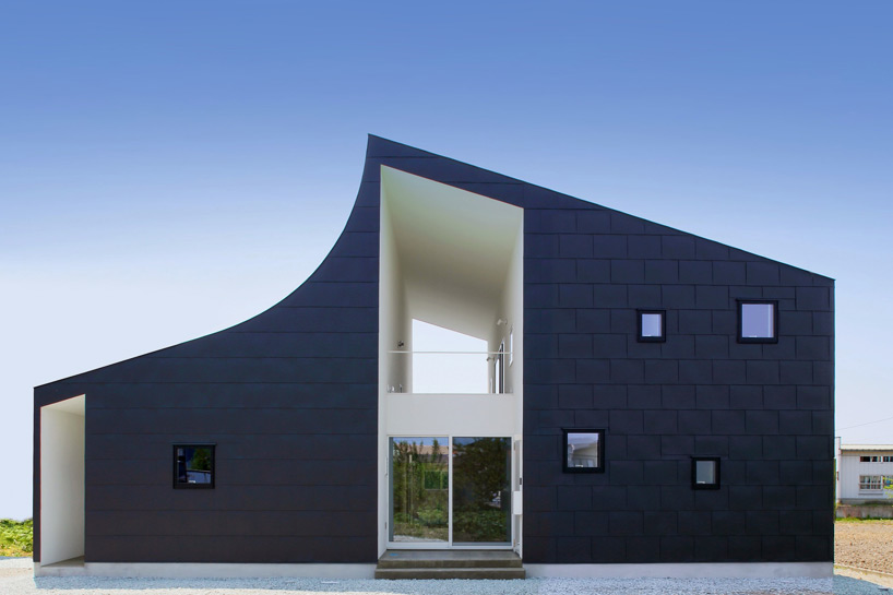 curved roof defines KHT house by international royal architecture
