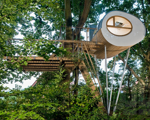 baumraum places elliptical pod around two oaks for treehouse djuren