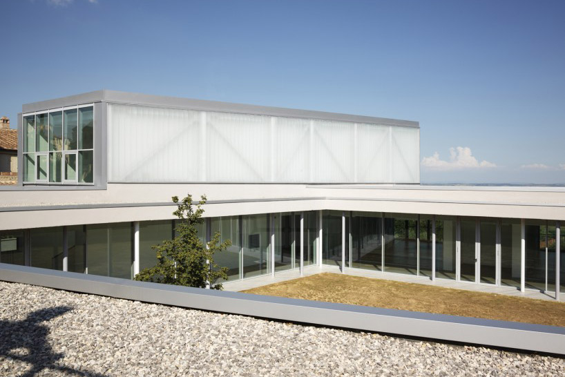 studio milani cantilevers the whale primary school above landscape