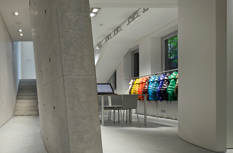 tadao ando defines duvetica showroom in milan with inclined cement wall