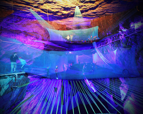 massive underground trampolines are suspended within a welsh mining cavern