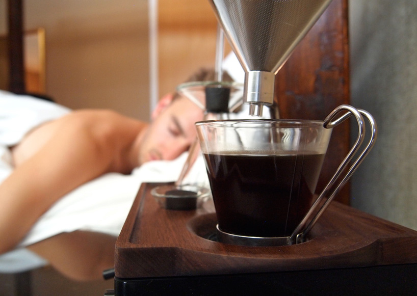 close up view of coffee maker, alarm clock and cup of coffee isolated on  red Stock Photo by LightFieldStudios