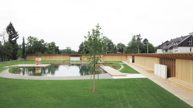 herzog & de meuron creates natural bathing pond for naturbad riehen