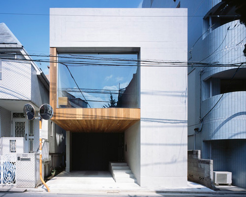 apollo architects arranges frame house around large window in tokyo