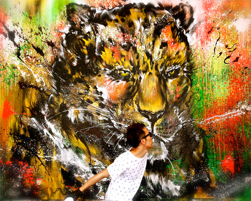 hua tunan sprays and splatters paint to form leopard's face