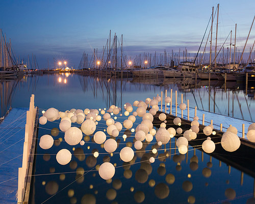 luminous lanterns form sensual wave in la grande motte, france